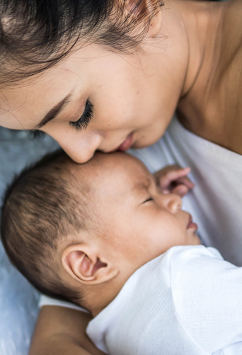 baby sleeping calmly beside mommy 